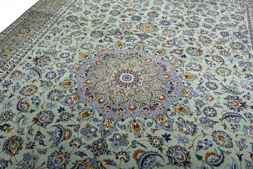 Backside of handmade 2000s Kashan rug showing knot structure and weave density