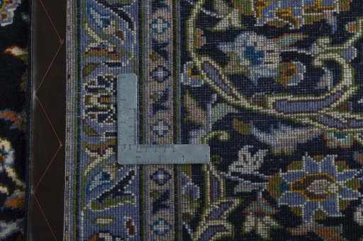 Backside of handmade 2000s Kashan rug showing knot structure and weave density