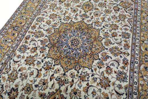 Backside of handmade 2000s Kashan rug showing knot structure and weave density