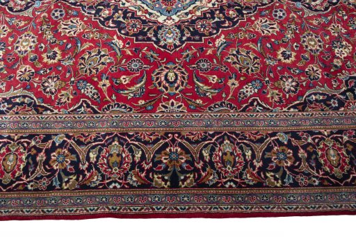 Corner detail of 2000s Kashan rug showing border pattern and Wool pile