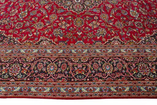 Corner detail of 2000s Kashan rug showing border pattern and Wool pile