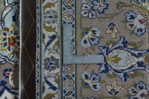 Backside of handmade 2000s Kashan rug showing knot structure and weave density