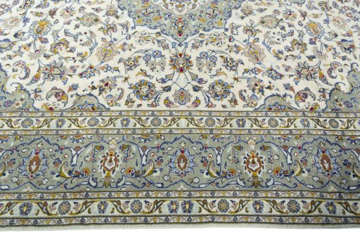 Corner detail of 2000s Kashan rug showing border pattern and Wool pile