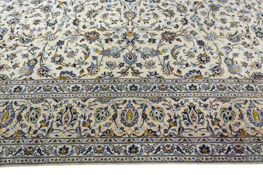 Corner detail of 2000s Kashan rug showing border pattern and Wool pile