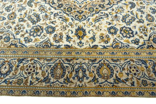 Corner detail of 2000s Kashan rug showing border pattern and Wool pile