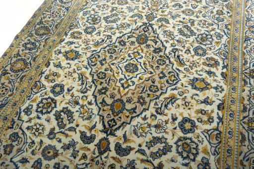 Backside of handmade 2000s Kashan rug showing knot structure and weave density
