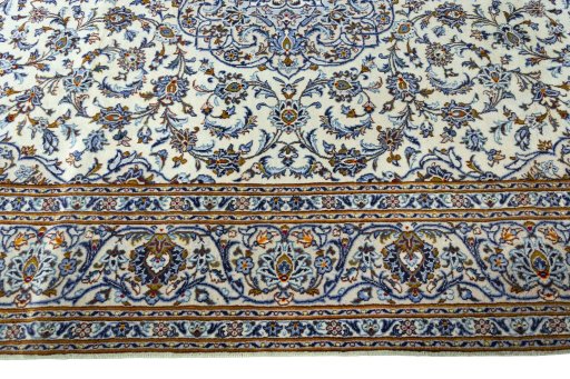 Corner detail of 2000s Kashan rug showing border pattern and Wool pile