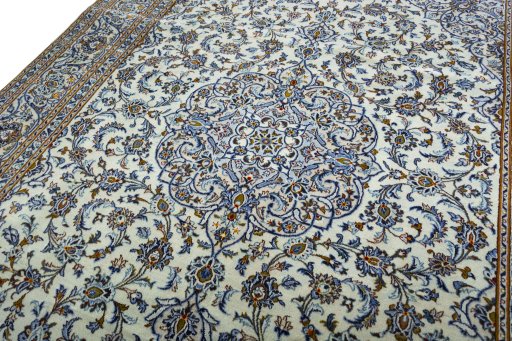 Backside of handmade 2000s Kashan rug showing knot structure and weave density