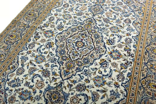 Backside of handmade 2000s Kashan rug showing knot structure and weave density