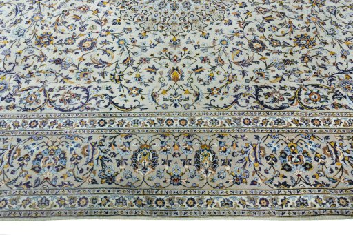 Corner detail of 2000s Kashan rug showing border pattern and Cork pile