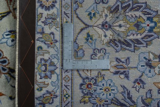 Backside of handmade 2000s Kashan rug showing knot structure and weave density