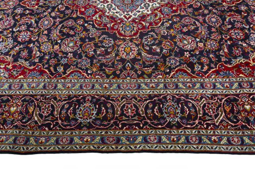 Corner detail of 2000s Kashan rug showing border pattern and Wool pile