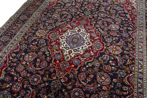 Backside of handmade 2000s Kashan rug showing knot structure and weave density