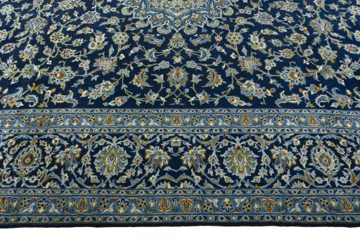 Corner detail of 2000s Kashan rug showing border pattern and Wool pile