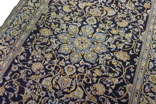 Backside of handmade 1970s Kashan rug showing knot structure and weave density