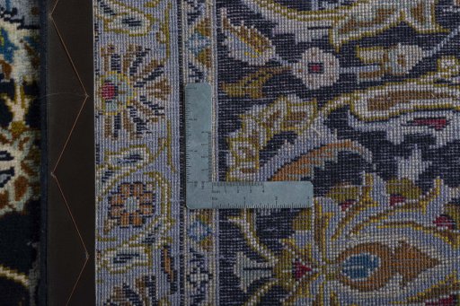 Backside of handmade 2000s Kashan rug showing knot structure and weave density