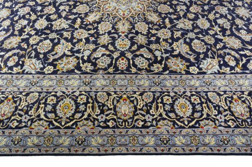 Corner detail of 2000s Kashan rug showing border pattern and Wool pile