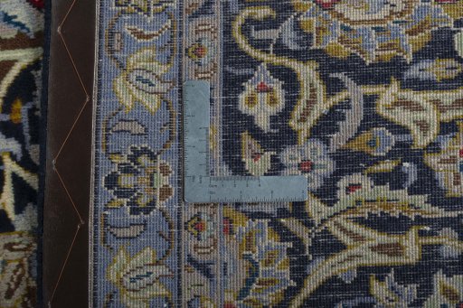 Backside of handmade 2000s Kashan rug showing knot structure and weave density
