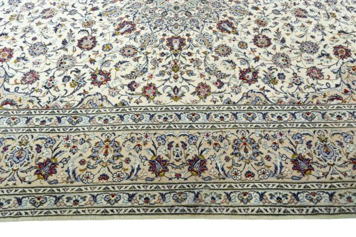 Corner detail of 2000s Kashan rug showing border pattern and Wool pile