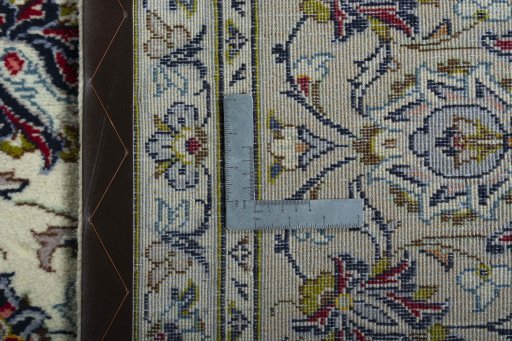 Backside of handmade 2000s Kashan rug showing knot structure and weave density
