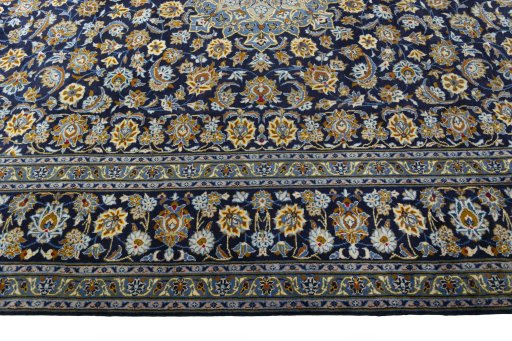 Corner detail of 2000s Kashan rug showing border pattern and Wool pile