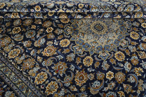 Close-up detail of 2000s Kashan rug from Iran / Persia showing Wool weave