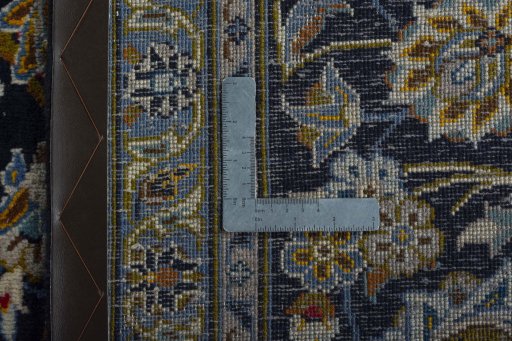 Backside of handmade 2000s Kashan rug showing knot structure and weave density