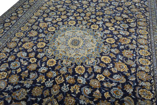 Backside of handmade 2000s Kashan rug showing knot structure and weave density