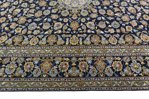 Corner detail of 2000s Kashan rug showing border pattern and Wool pile
