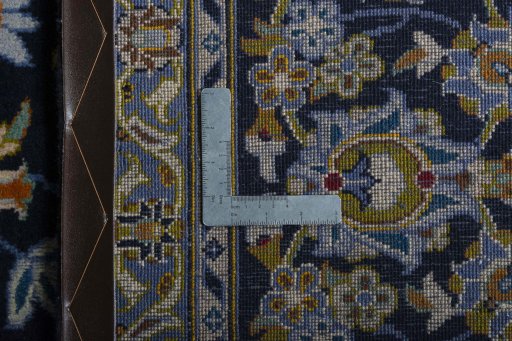 Backside of handmade 2000s Kashan rug showing knot structure and weave density