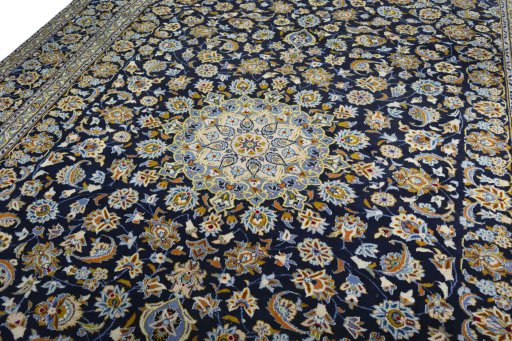 Backside of handmade 2000s Kashan rug showing knot structure and weave density