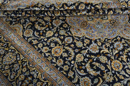 Close-up detail of 2000s Kashan rug from Iran / Persia showing Wool weave