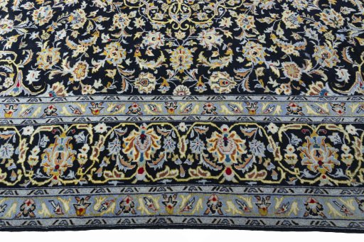 Corner detail of 2000s Kashan rug showing border pattern and Wool pile