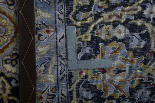 Backside of handmade 2000s Kashan rug showing knot structure and weave density