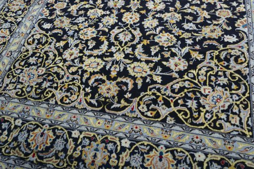 Close-up detail of 2000s Kashan rug from Iran / Persia showing Wool weave