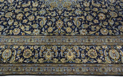 Corner detail of 2000s Kashan rug showing border pattern and Wool pile