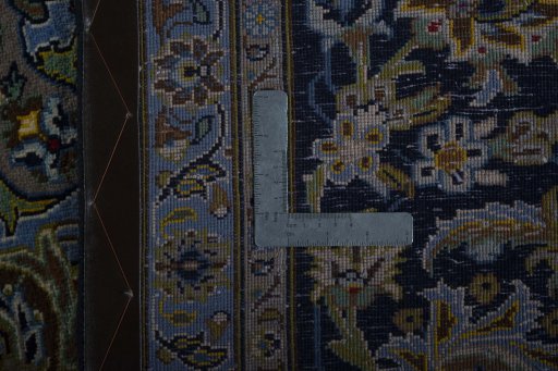 Backside of handmade 2000s Kashan rug showing knot structure and weave density