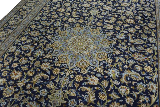 Backside of handmade 2000s Kashan rug showing knot structure and weave density