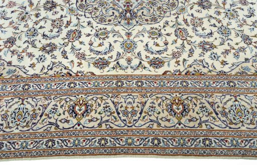 Corner detail of 2000s Kashan rug showing border pattern and Wool pile