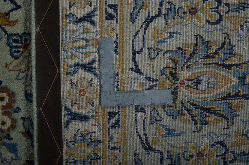 Backside of handmade 1970s Kashan rug showing knot structure and weave density