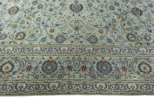 Corner detail of 2000s Kashan rug showing border pattern and Wool pile