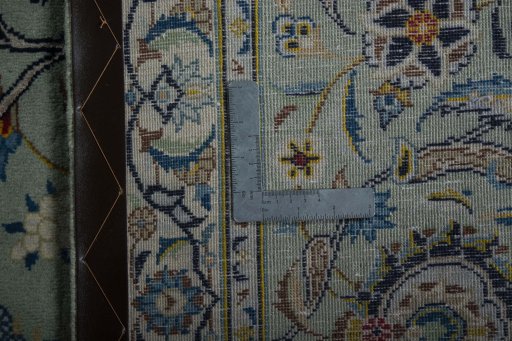 Backside of handmade 2000s Kashan rug showing knot structure and weave density