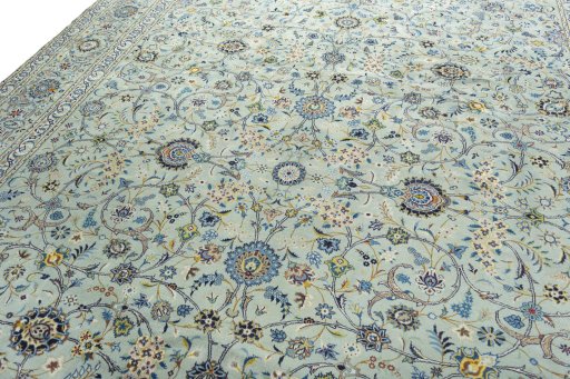 Backside of handmade 2000s Kashan rug showing knot structure and weave density