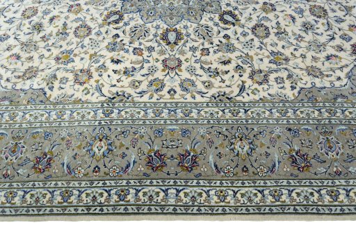 Corner detail of 2000s Kashan rug showing border pattern and Cork pile