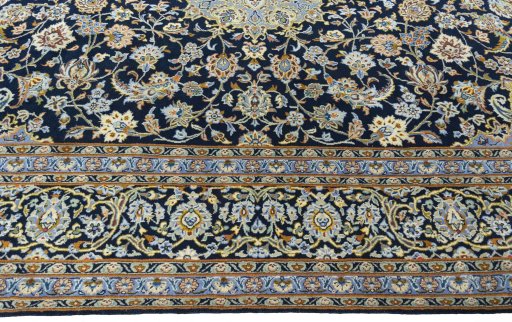 Corner detail of 2000s Kashan rug showing border pattern and Wool pile