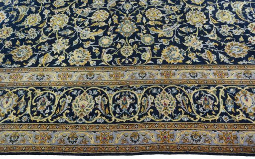 Corner detail of 2000s Kashan rug showing border pattern and Wool pile