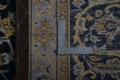 Backside of handmade 2000s Kashan rug showing knot structure and weave density