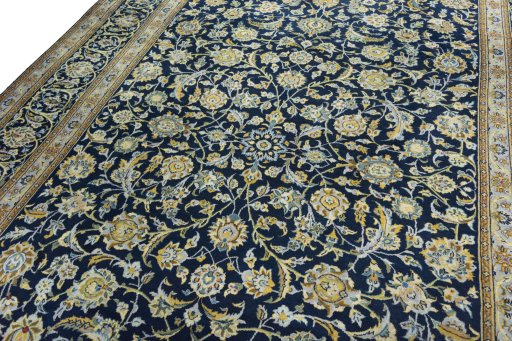 Backside of handmade 2000s Kashan rug showing knot structure and weave density