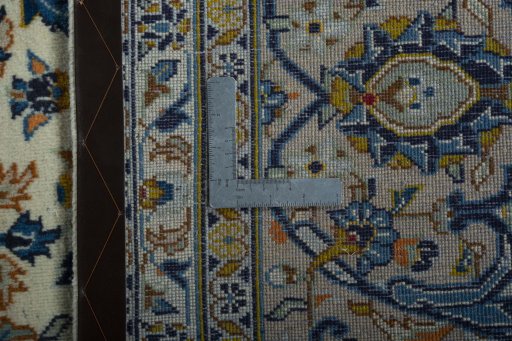 Backside of handmade 2000s Kashan rug showing knot structure and weave density