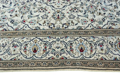 Corner detail of 2000s Kashan rug showing border pattern and Wool pile